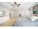 Serene main bedroom with a tray ceiling, ceiling fan, and plush bedding for a comfortable retreat at 12433 N Exeter Way, Durham, NC 27703