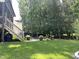The home features a backyard with a fire pit, trees, and a porch offering a great space to relax and entertain at 127 Sanderway Dr, Chapel Hill, NC 27516