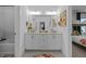 Bright bathroom with double vanity, a large mirror, and a gray tile floor at 127 Sanderway Dr, Chapel Hill, NC 27516