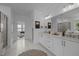 A bright bathroom features double sinks, quartz counters, and a large mirror, exuding modern elegance at 127 Sanderway Dr, Chapel Hill, NC 27516