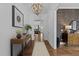 Foyer with hardwood floors, decorative table with flowers, and pendant lighting at 127 Sanderway Dr, Chapel Hill, NC 27516