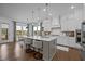 Bright, modern kitchen with an island, white cabinets, stainless appliances, and a breakfast nook bathed in natural light at 127 Sanderway Dr, Chapel Hill, NC 27516