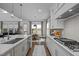 Bright kitchen with sleek white cabinetry, stainless steel appliances, and a center island, seamlessly connects with dining area at 127 Sanderway Dr, Chapel Hill, NC 27516