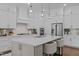 Modern kitchen with an island and pendant lighting above with stainless steel appliances at 127 Sanderway Dr, Chapel Hill, NC 27516