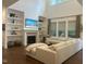 Bright living room with a fireplace, large windows, a comfortable sectional, and built in shelving at 127 Sanderway Dr, Chapel Hill, NC 27516