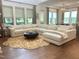 Spacious living room featuring hardwood floors, large sectional, and large windows at 127 Sanderway Dr, Chapel Hill, NC 27516