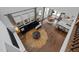 Bright living room featuring hardwood floors, a modern sofa, and large windows at 127 Sanderway Dr, Chapel Hill, NC 27516