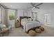 Spacious main bedroom featuring a ceiling fan, plush bedding, and natural light at 127 Sanderway Dr, Chapel Hill, NC 27516