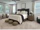 Comfortable main bedroom with decorative headboard, furnishings and ample natural light at 127 Sanderway Dr, Chapel Hill, NC 27516