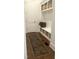 A well-organized mudroom with hooks, storage baskets, a bench and a stylish runner that leads to an entrance door at 127 Sanderway Dr, Chapel Hill, NC 27516