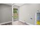 Basement room with vinyl flooring, door leading to the backyard, and hot water tank at 1284 Railroad St, Henderson, NC 27536