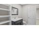 Bathroom with dark vanity and an open doorway to additional rooms at 1284 Railroad St, Henderson, NC 27536