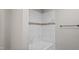 Bathroom shower with marble-look tiles and a decorative accent stripe at 1284 Railroad St, Henderson, NC 27536