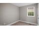 Cozy bedroom featuring neutral carpeting and a large window at 1284 Railroad St, Henderson, NC 27536