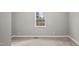 Neutral bedroom with carpet, white trim and a window for natural light at 1284 Railroad St, Henderson, NC 27536