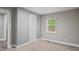 Neutral bedroom with a window letting in natural light and carpet flooring at 1284 Railroad St, Henderson, NC 27536