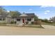 Charming single-story home featuring a red front door, grey siding, and well-maintained landscaping at 1284 Railroad St, Henderson, NC 27536