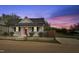 Charming single-story home featuring a red front door, grey siding, and well-maintained landscaping at 1284 Railroad St, Henderson, NC 27536