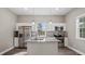 Well-lit kitchen featuring stainless steel appliances, a granite island, and stylish backsplash at 1284 Railroad St, Henderson, NC 27536