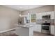 Bright kitchen with stainless steel appliances, granite countertops, and an island with a sink at 1284 Railroad St, Henderson, NC 27536