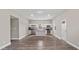 Open-concept kitchen with stainless steel appliances, an island, and sleek white cabinetry at 1284 Railroad St, Henderson, NC 27536