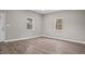 Bright living room with modern floors, large windows, and crisp white trim at 1284 Railroad St, Henderson, NC 27536