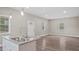 Spacious living room with modern flooring and large windows bringing in plenty of natural light at 1284 Railroad St, Henderson, NC 27536