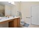 Bathroom with a light wood vanity and a large mirror, a toilet, and a shower at 1307 Seattle Slew Ln, Cary, NC 27519