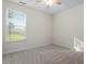 Bright bedroom with carpet, window, and neutral walls at 1307 Seattle Slew Ln, Cary, NC 27519