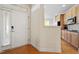 Inviting foyer with hardwood floors, a white front door, and access to the kitchen at 1307 Seattle Slew Ln, Cary, NC 27519