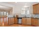 Modern kitchen featuring stainless steel appliances, wooden cabinets, and an open layout at 1307 Seattle Slew Ln, Cary, NC 27519