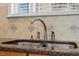 Close-up of kitchen sink with tile backsplash and modern faucet fixtures at 1307 Seattle Slew Ln, Cary, NC 27519