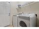 A full sized washing machine and dryer sitting in a laundry room with a wire rack at 1307 Seattle Slew Ln, Cary, NC 27519