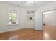 Well-lit living room with hardwood floors, an open floor plan, and backyard view at 1307 Seattle Slew Ln, Cary, NC 27519