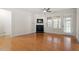 Open-concept living room featuring hardwood floors, a cozy fireplace, and a neutral color palette at 1307 Seattle Slew Ln, Cary, NC 27519