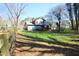 Exterior of home with a fenced backyard and an expansive green lawn at 1400 Rainwood Ln, Raleigh, NC 27615