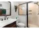 Bathroom featuring a modern shower, marble countertop vanity, and decorative wall basket with flower accent at 1400 Rainwood Ln, Raleigh, NC 27615