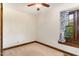 Neutral bedroom showcasing window with patterned curtain, wood trim, carpet and ceiling fan with light at 1400 Rainwood Ln, Raleigh, NC 27615