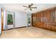 Bedroom featuring wood paneled accent wall, two windows, carpet and ceiling fan with light at 1400 Rainwood Ln, Raleigh, NC 27615
