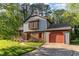 Charming home with a brick and siding exterior, featuring a well-manicured lawn and mature trees at 1400 Rainwood Ln, Raleigh, NC 27615