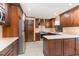 Spacious kitchen featuring stainless steel appliances, wooden cabinets, and light countertops at 1400 Rainwood Ln, Raleigh, NC 27615