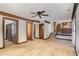 Living room showcasing beautiful hardwood trim, carpeting, ceiling fan, and stairway to kitchen at 1400 Rainwood Ln, Raleigh, NC 27615
