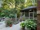 A peaceful deck area surrounded by lush greenery and mature trees at 1425 Bascomb Dr, Raleigh, NC 27614