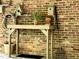 Charming back porch featuring a gardening bench, potting supplies and brick background at 1425 Bascomb Dr, Raleigh, NC 27614