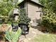 Exterior with a stone patio, wrought iron seating, and landscaped yard at 1425 Bascomb Dr, Raleigh, NC 27614