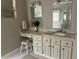 This is a bathroom featuring a double vanity with granite countertops, multiple drawers, and a tiled floor at 1425 Bascomb Dr, Raleigh, NC 27614