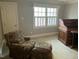 This is a bedroom with a comfortable floral-patterned armchair and a traditional wooden writing desk at 1425 Bascomb Dr, Raleigh, NC 27614