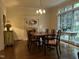 Bright dining room boasts hardwood floors, fireplace, and lots of natural light at 1425 Bascomb Dr, Raleigh, NC 27614