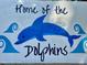 Decorative 'Home of the Dolphins' sign with playful dolphin and wave accents at 1425 Bascomb Dr, Raleigh, NC 27614
