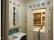 This is a bright laundry room, featuring a sink, storage cabinets, and a washer and dryer at 1425 Bascomb Dr, Raleigh, NC 27614